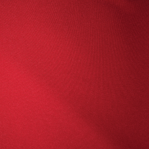 Close up of an apple red colored polyester tablecloth.