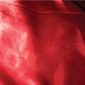 Close up of a apple red colored silk tablecloth.