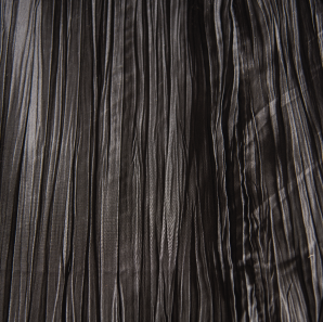 Close up of a black crinkled accordion tablecloth.