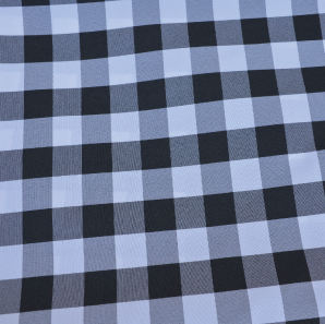 Close up of a black gingham check polyester tablecloth.