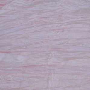 Close up of a blush rose crinkled accordion tablecloth.