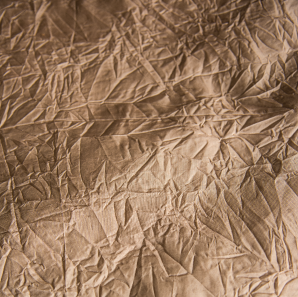 Close up of a champagne crushed accordion tablecloth.