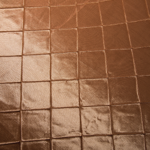 Close up of a champagne colored tuck overlay