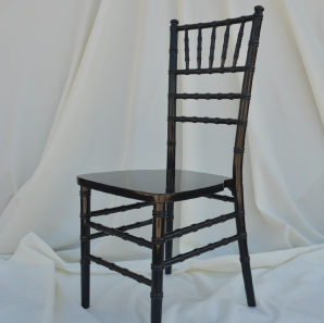 Black Chiavari chair in front of  a white backdrop.