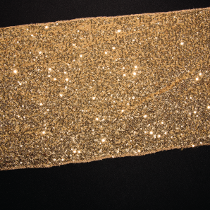 Close up of a gold sequined table runner.