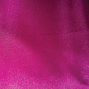 Close up of a hot pink colored tablecloth.
