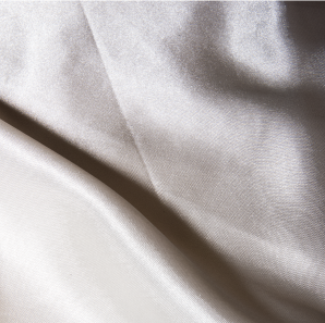 Close up of a ivory colored silk tablecloth.