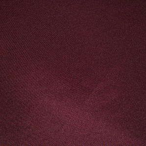 Close up of a maroon polyester tablecloth.