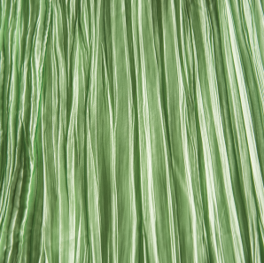 Close up of a mint green colored crinkled accordion tablecloth.