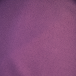 Close up of a purple polyester tablecloth.