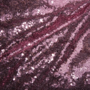 Close up of a purple sequined tablecloth.
