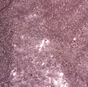 Close up of a rose pink sequined tablecloth.