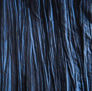 Close up of a royal blue crinkled accordion tablecloth.