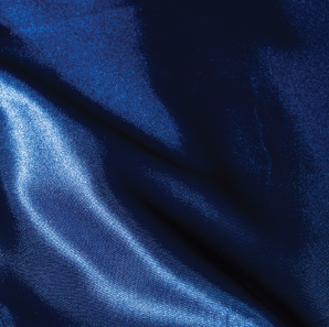 Close up of a royal blue silk tablecloth.