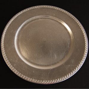 Close up of a silver charge on top of a black tablecloth.