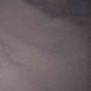 Close up of a silver colored polyester tablecloth.