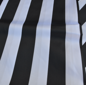 Close up of a white and black striped table runner.