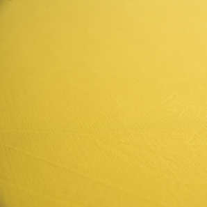 Close up of a yellow spandex tablecloth.